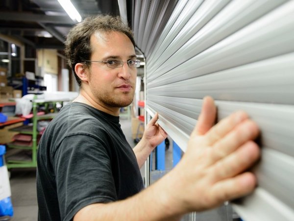 Mitarbeiter aus der Produktion der in die Kamera lacht